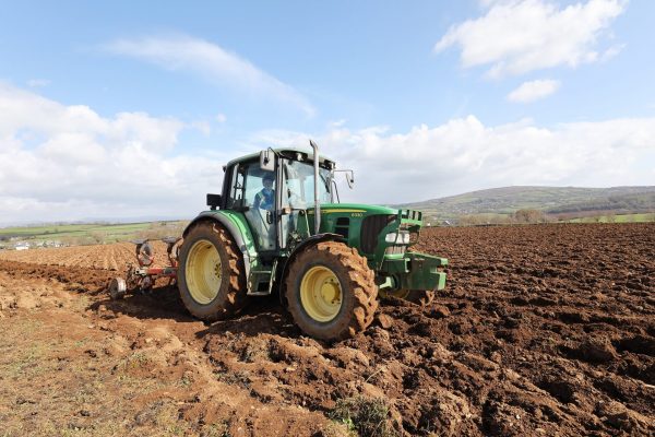 Image of a student in a tractor in a ploughed field