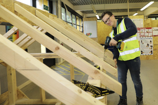 Carpenter working on roof trusses