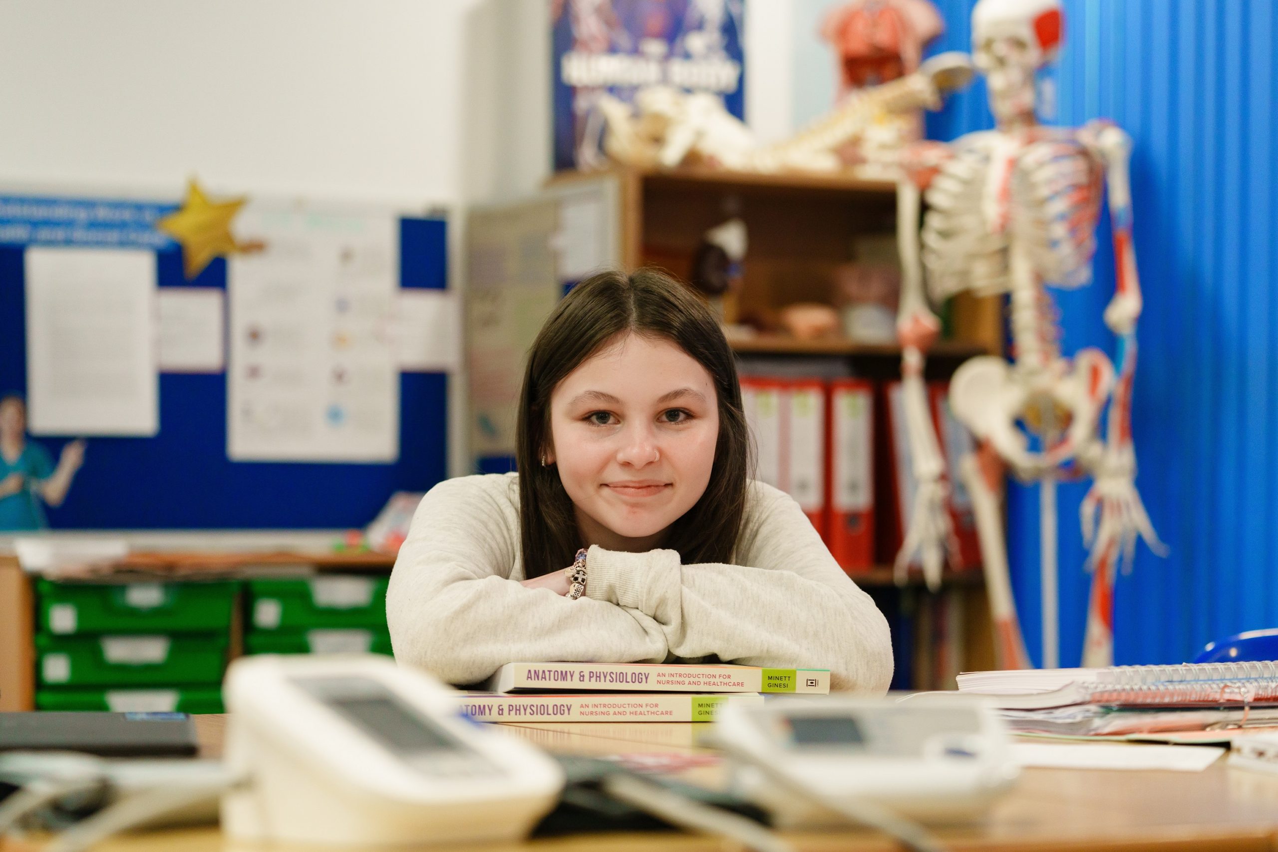 Student sitting at a desk with books